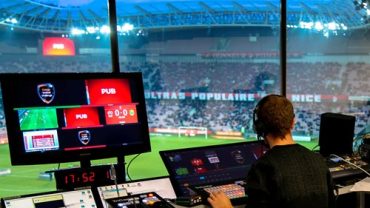 Operator managing real-time graphics for sports and live events in a stadium